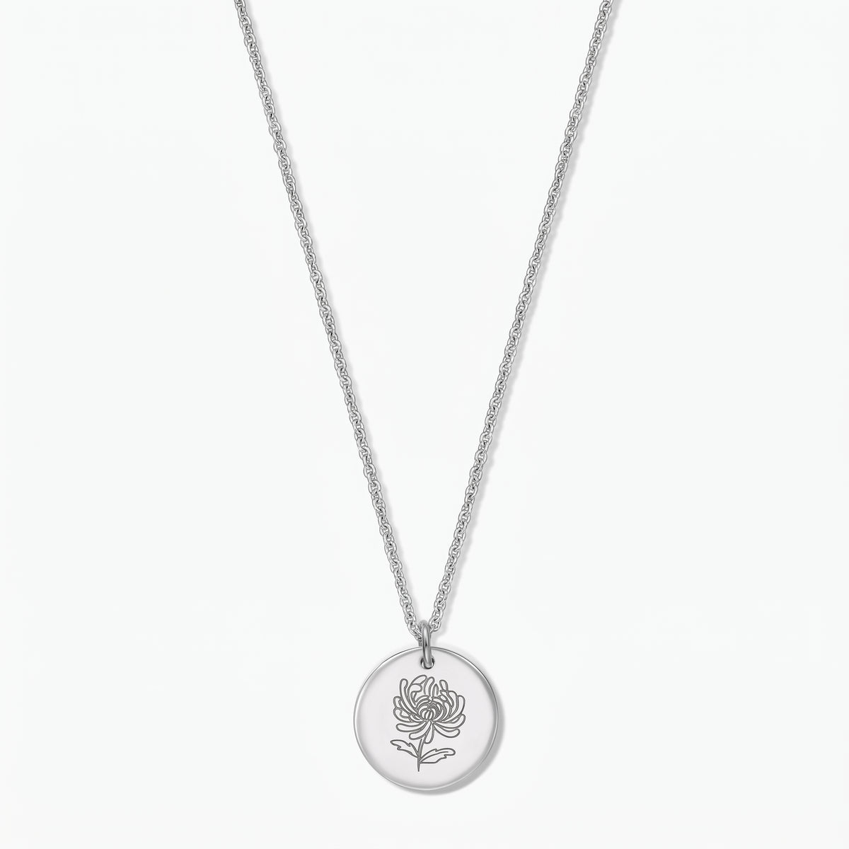 Sterling silver birthflower necklace with a round disc pendant engraved with a chrysanthemum on a fine chain, photographed on a white background.