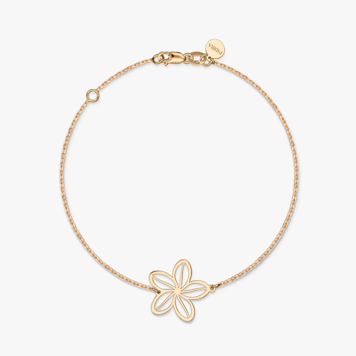 A minimalist gold bracelet featuring a delicate flower charm on a solid white background.