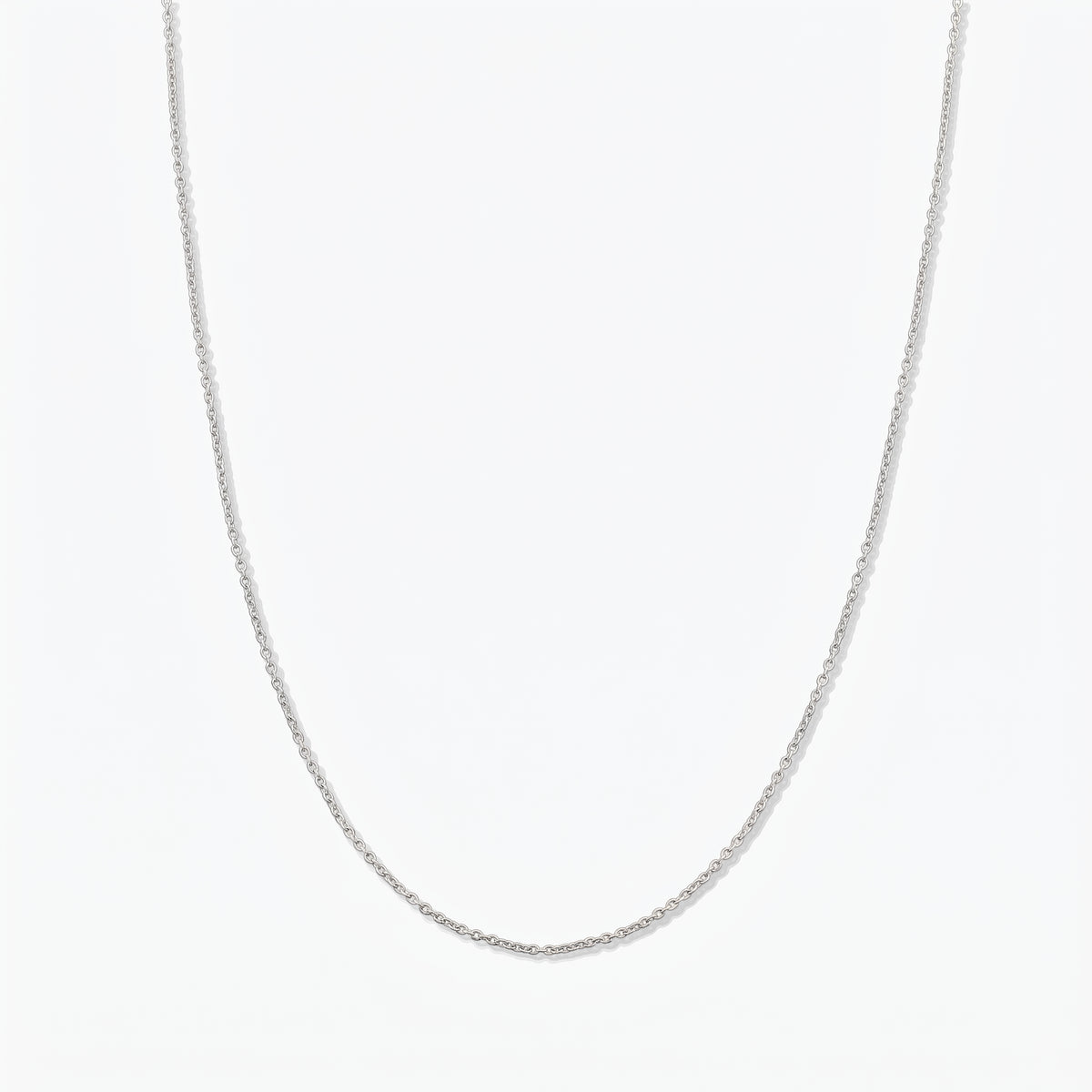 Simple sterling silver chain necklace photographed on a white background.