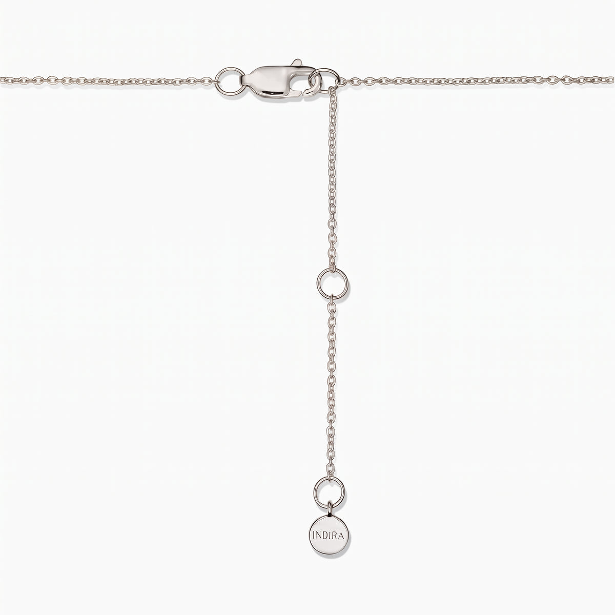 Close-up of a sterling silver necklace clasp with an adjustable extender chain and a small round Indira tag on a white background.