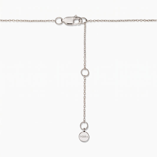 Close-up of a sterling silver necklace clasp with an adjustable extender chain and a small round Indira tag on a white background.