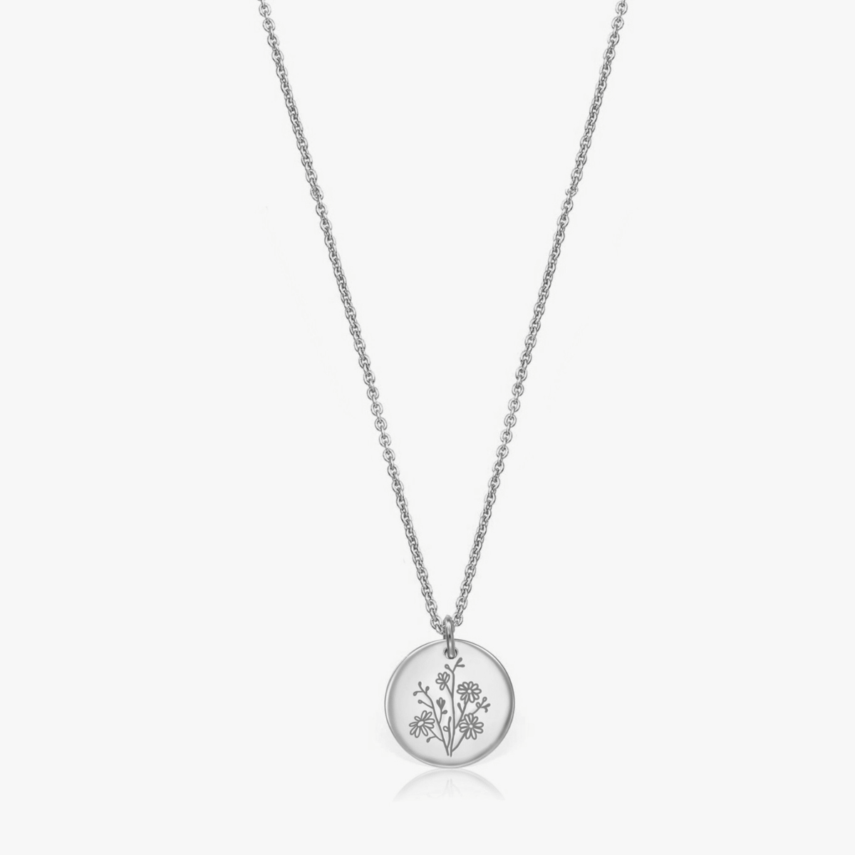 Silver necklace with a round pendant featuring a birth flower design for September, known as Aster.