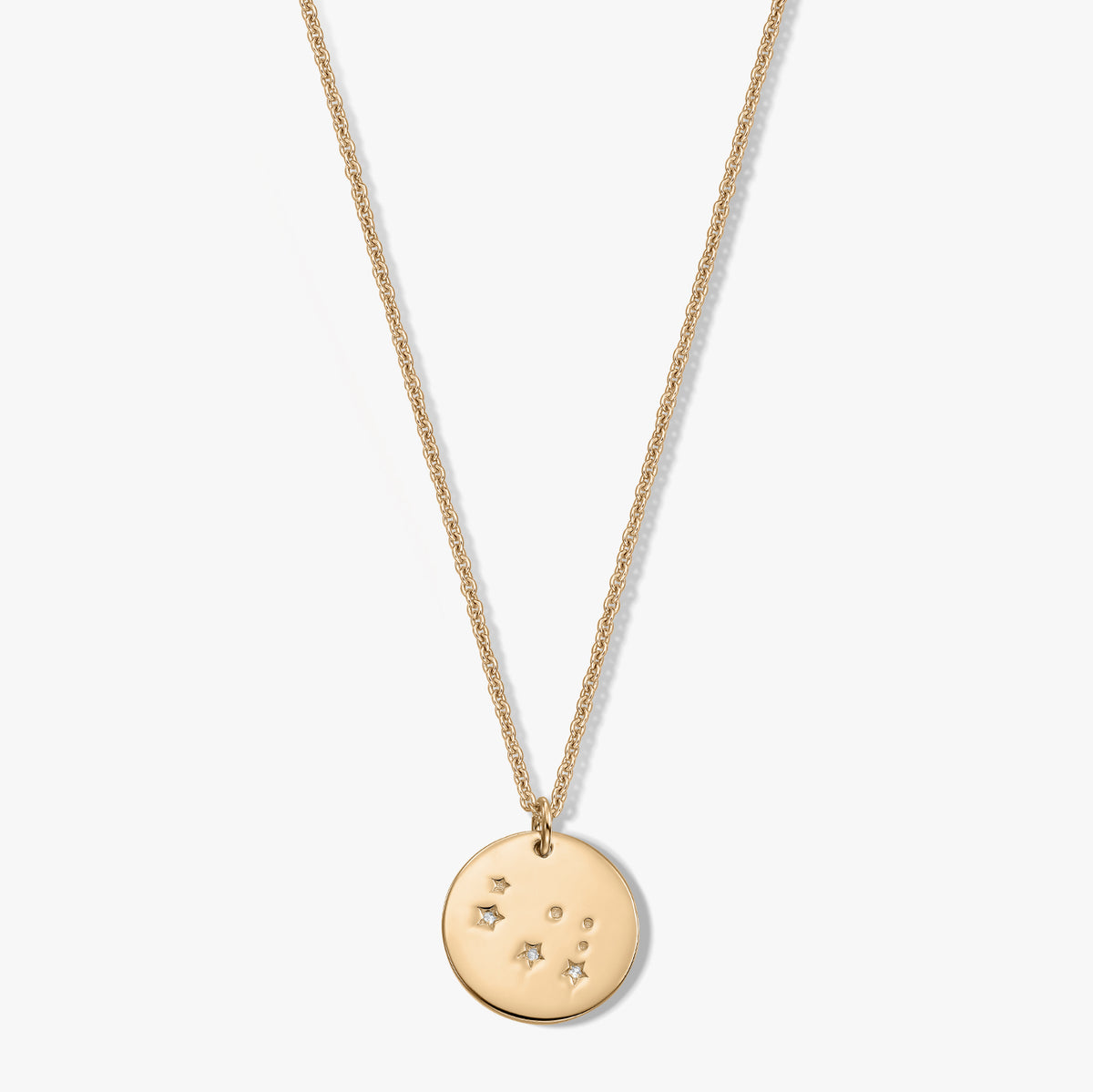 Dainty sterling silver Gemini zodiac disc pendant necklace with white sapphire on a white background.