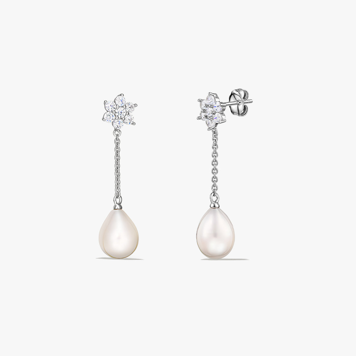Pair of sterling silver drop earrings with teardrop cultured pearls hanging from a short chain and a small sparkling cluster at the stud, on a white background.