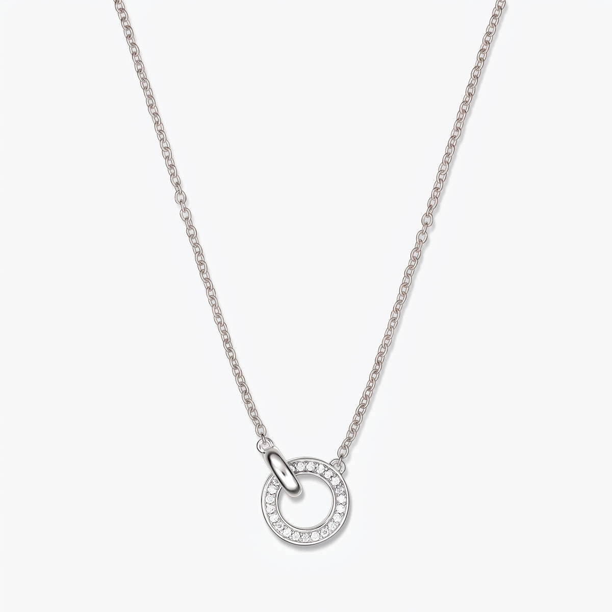Linked Silver Necklace with a double circle pendant accented by small clear stones on a fine silver chain, photographed on a white background.