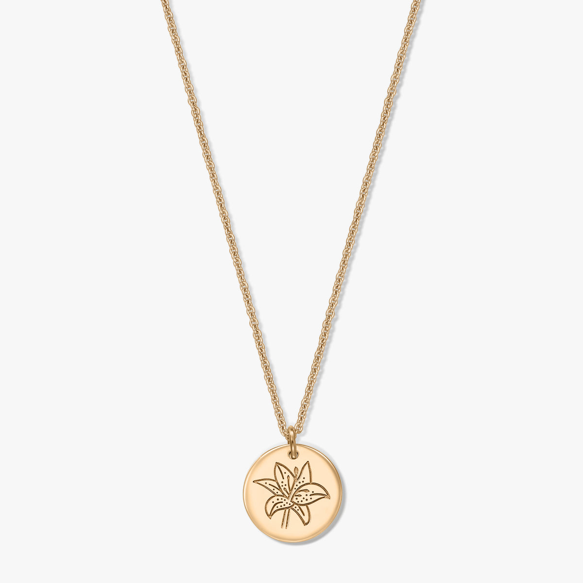 Gold‑tone 925 silver necklace with a round disc pendant engraved with a lily flower, shown centered on a white background.