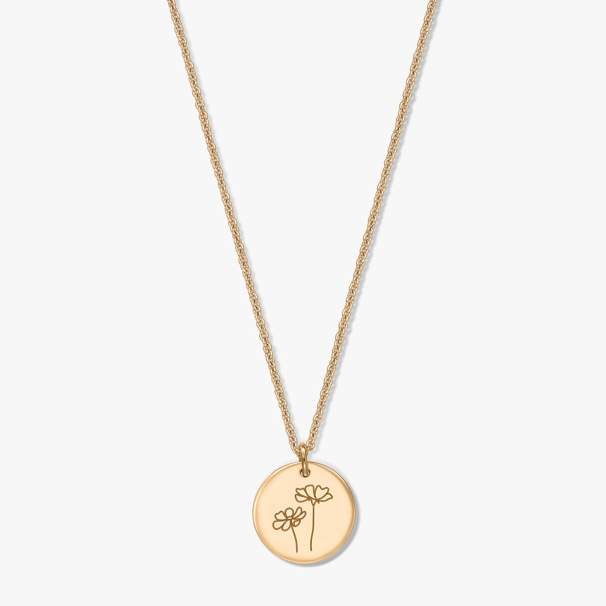 Gold-plated silver necklace with a round disc pendant engraved with two cosmos flowers, photographed on a white background.