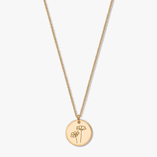 Gold-plated silver necklace with a round disc pendant engraved with two cosmos flowers, photographed on a white background.