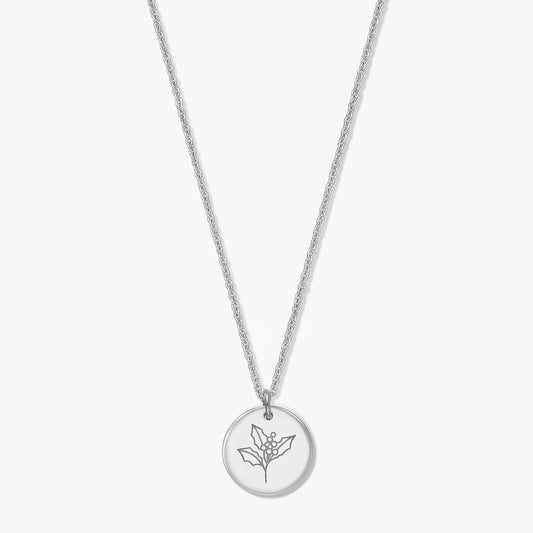 Sterling silver birthflower necklace with a round pendant engraved with a holly sprig, shown on a white background.