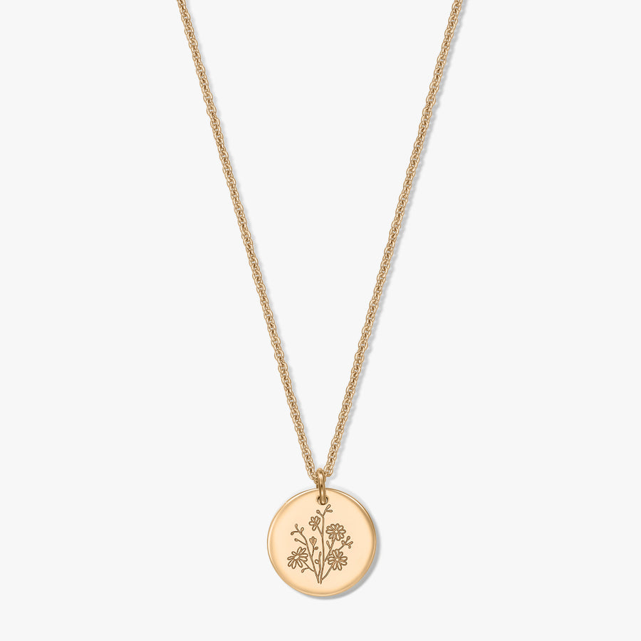 Gold-plated silver necklace with a delicate rope chain and round coin pendant engraved with an aster birthflower, isolated on a white background.