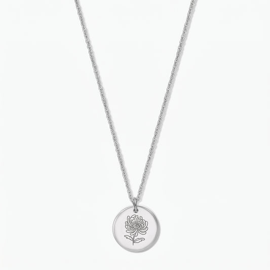 Sterling silver birthflower necklace with a round disc pendant engraved with a chrysanthemum on a fine chain, photographed on a white background.