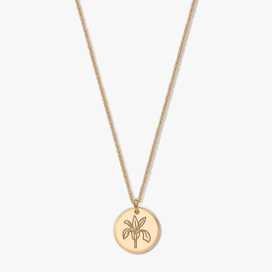 Gold‑tone birthflower necklace with a round pendant engraved with an iris, on a delicate chain, isolated on a white background.