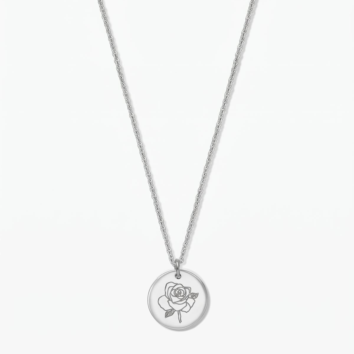 Sterling silver birthflower necklace with a round pendant engraved with a rose (June), photographed on a white background.