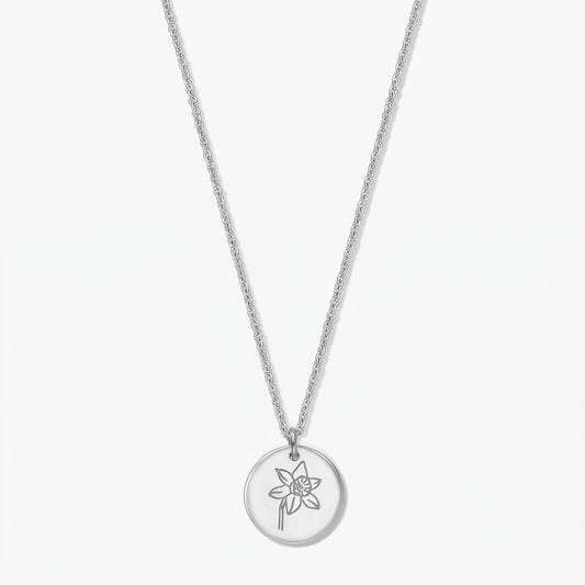 Sterling silver necklace with a round pendant engraved with a daffodil (March birth flower) on a white background.