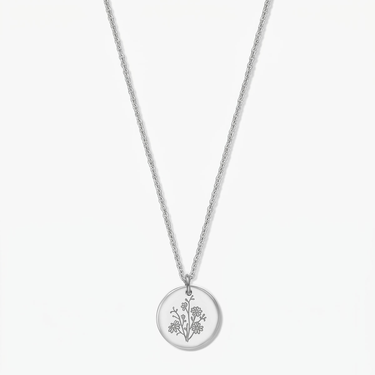 Birthflower Silver Necklace – September aster engraved round pendant in 925 silver on a delicate chain, isolated on a white background.