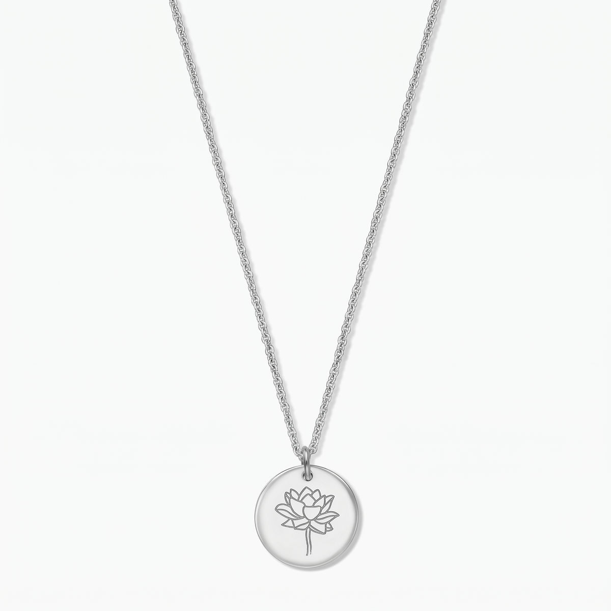 Sterling silver birthflower necklace with a round disc pendant engraved with a lotus (July), photographed on a white background.