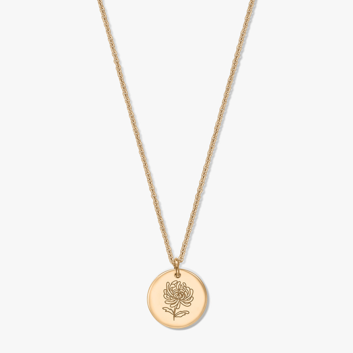 Gold-plated silver necklace with a round coin pendant engraved with a chrysanthemum, the November birthflower, on a white background.