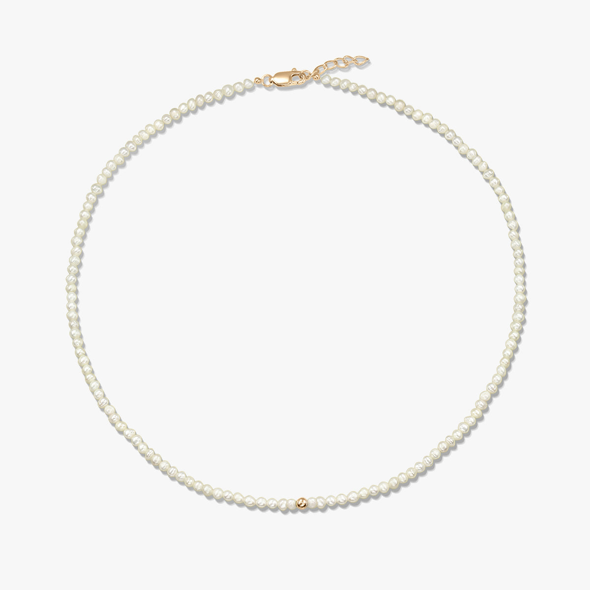 Square product image of a delicate natural pearl beaded necklace with a small 14K yellow gold bead accent and a yellow-gold lobster clasp with short extender, on a white background.