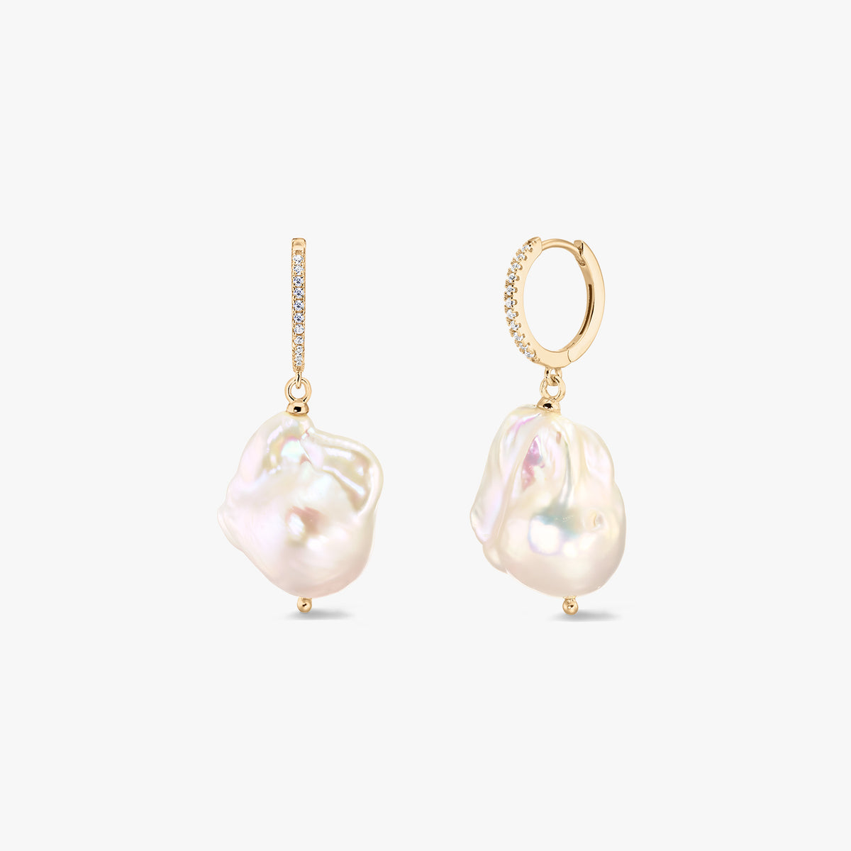 Pair of gold‑plated 925 silver huggie hoop earrings with pavé zirconia and large white baroque freshwater pearls on a white background.