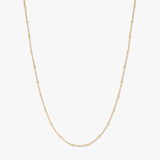 Gold-plated silver beaded chain necklace displayed on a white background, forming a gentle U shape with small bead stations along the chain.