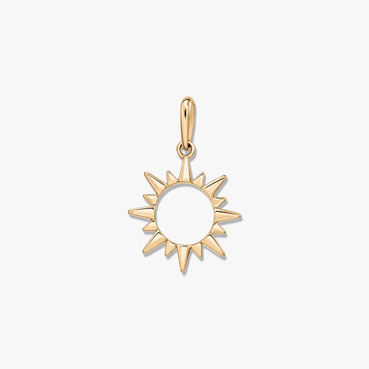 Polished yellow-gold sunburst pendant with an open center and bail, isolated on a white background.