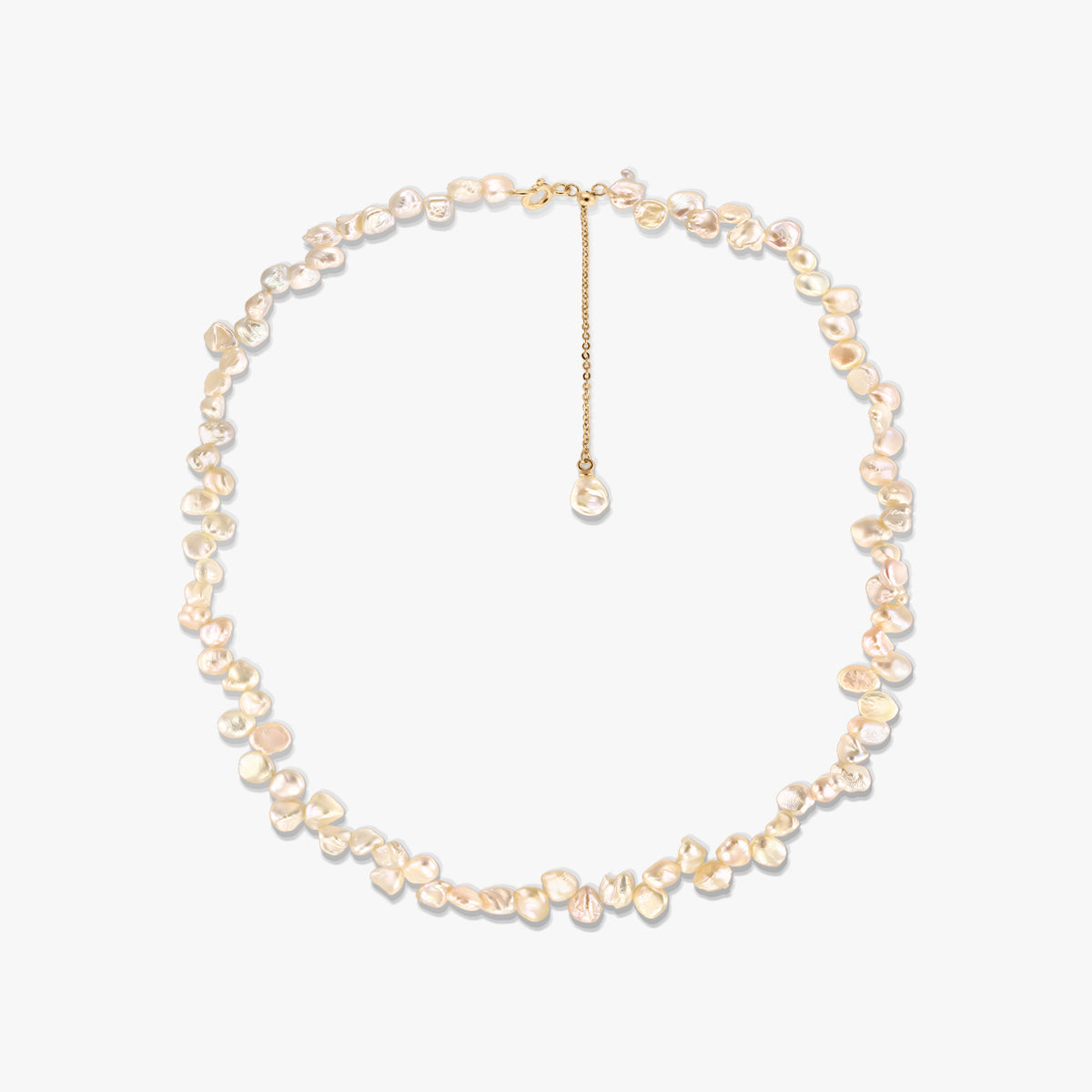 Gold-plated silver necklace with irregular pink keshi freshwater pearls and an adjustable chain extender, photographed on a white background.