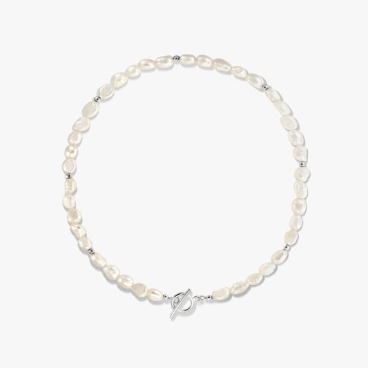 Square studio photo of a sterling silver and natural freshwater pearl necklace with small silver spacer beads and a toggle clasp on a white background.