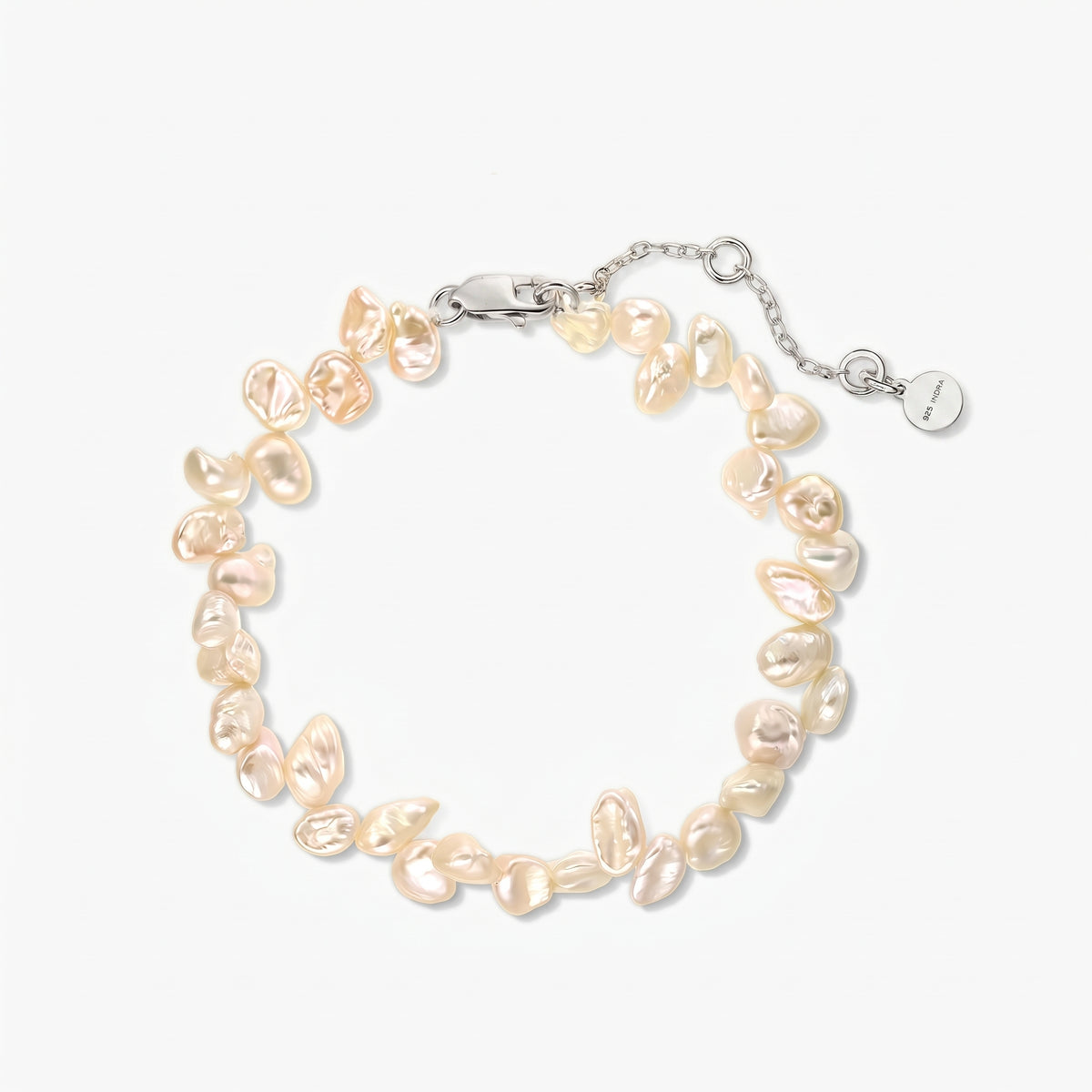 Square studio photo of a rhodium‑plated silver bracelet strung with irregular pink keshi freshwater pearls, shown in a circle on a white background with an adjustable chain and lobster clasp.