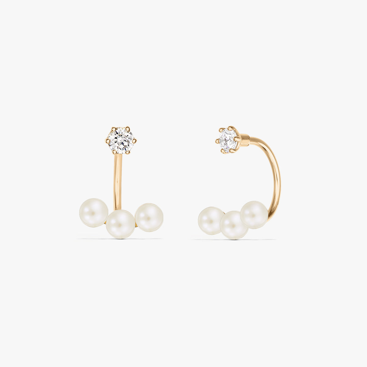 Square product photo of a pair of 14K yellow gold ear jacket earrings with a trio of natural pearls beneath a small round stud, on a pure white background.