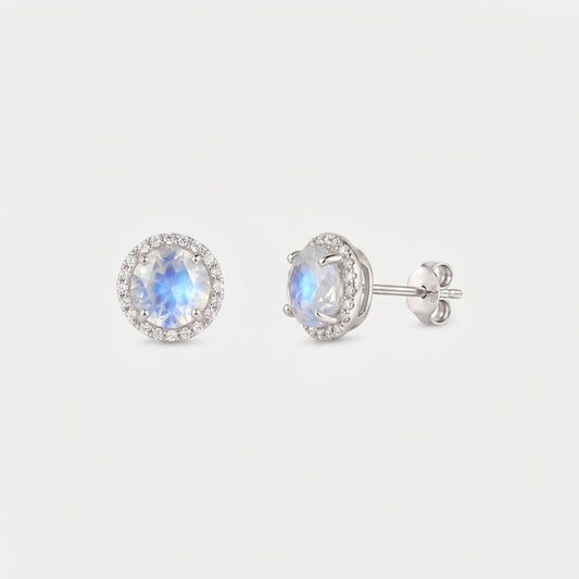 Pair of Keira 925 sterling silver moonstone halo stud earrings, one front view and one side view with butterfly back, on a white background.