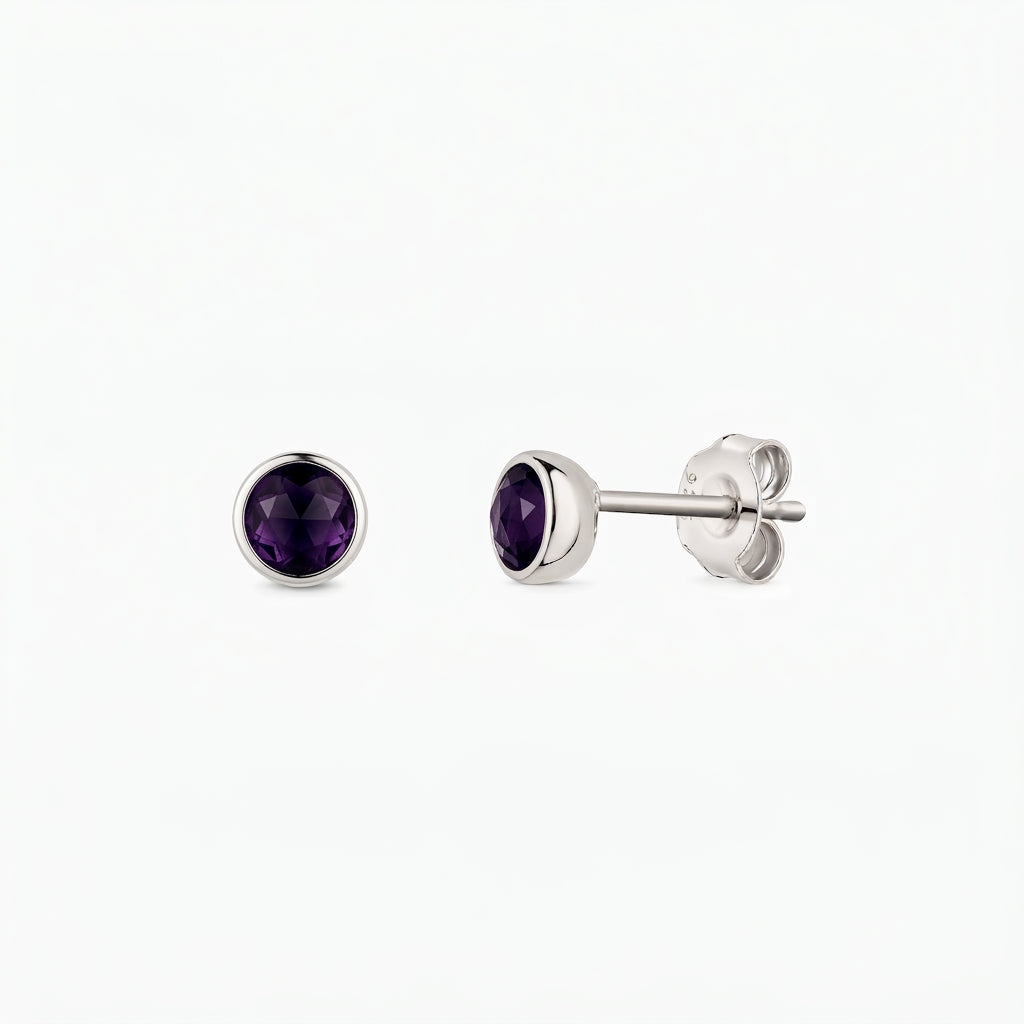Pair of sterling silver stud earrings with round faceted amethyst stones, bezel-set, shown front and side on a white background.