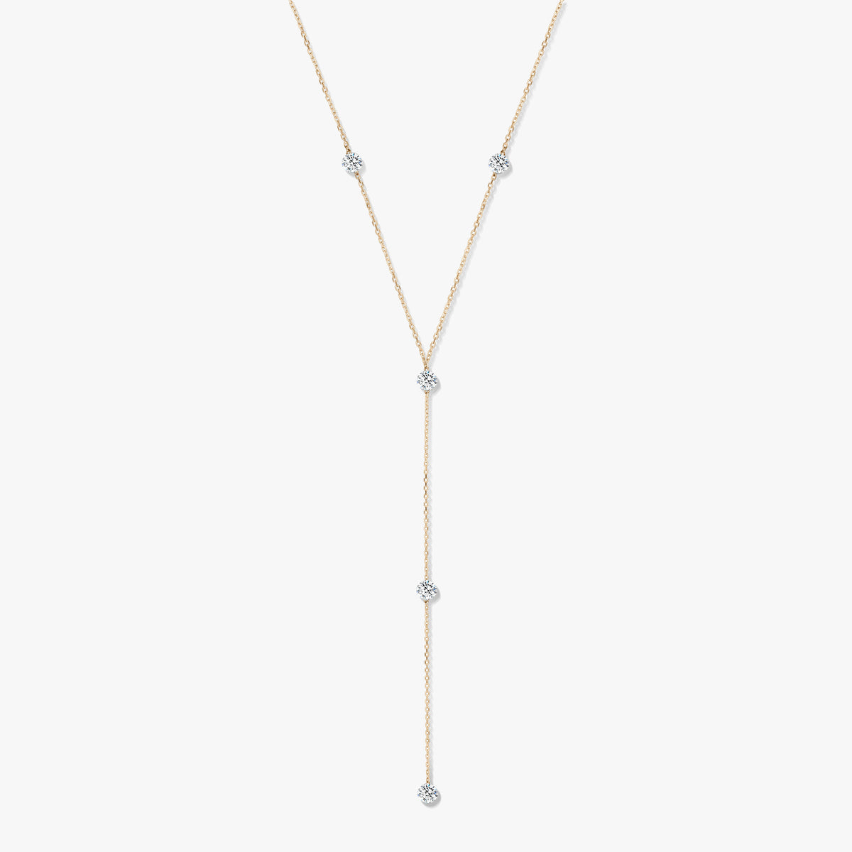 14K yellow gold diamond lariat necklace with five bezel-set round diamonds on a white background.