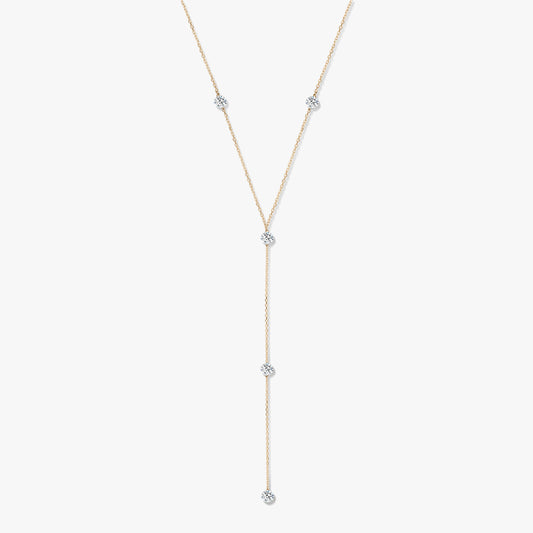 14K yellow gold diamond lariat necklace with five bezel-set round diamonds on a white background.