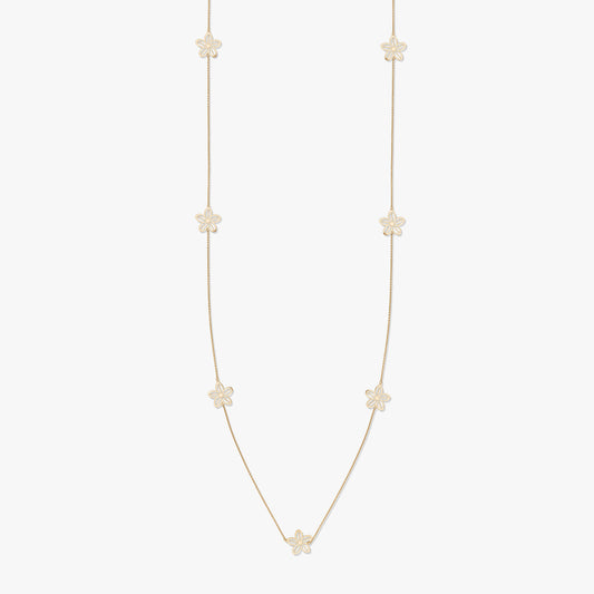Gold necklace with floral motifs on a white background