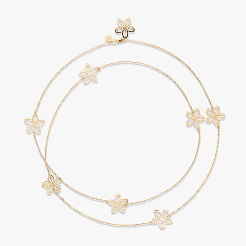 Gold necklace with floral designs on a white background.