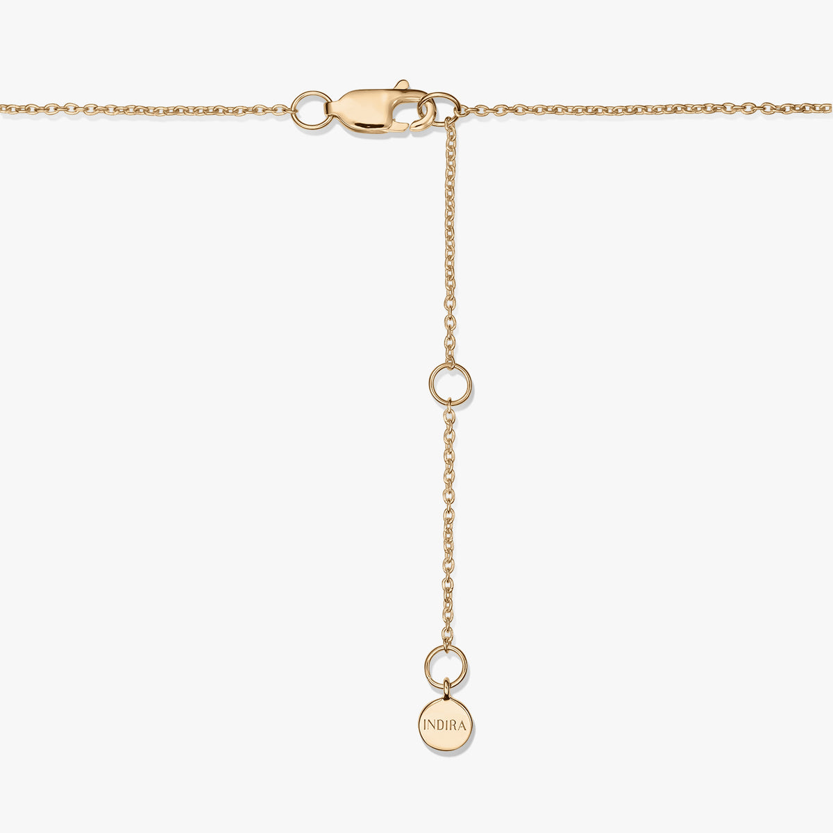 Close-up of a gold-plated sterling silver necklace clasp with an adjustable extender and a small round tag engraved “INDIRA,” on a white background.