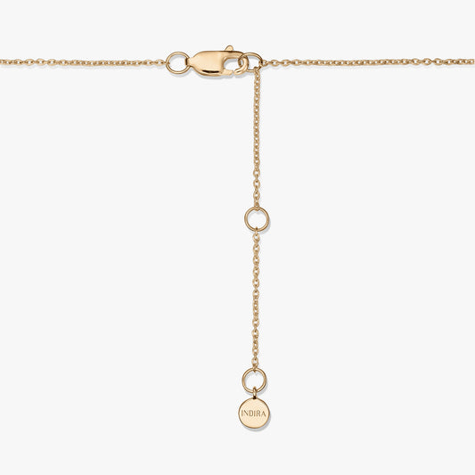 Close-up of a gold-plated sterling silver necklace clasp with an adjustable extender and a small round tag engraved “INDIRA,” on a white background.