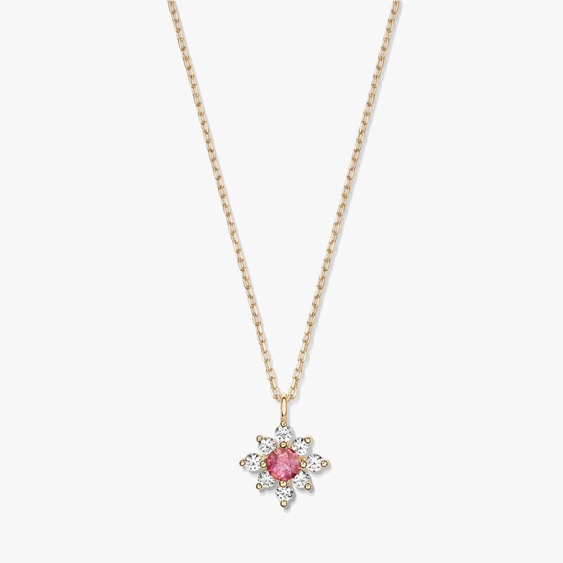 14K gold necklace with a floral pendant featuring a pink tourmaline center surrounded by white sapphires on a white background.