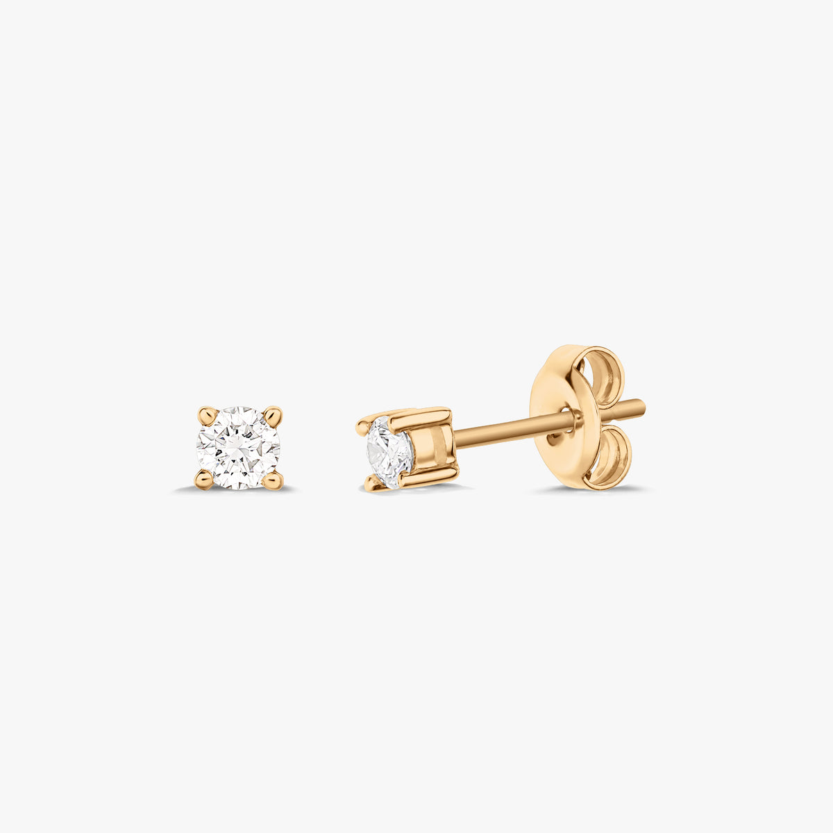 Pair of gold stud earrings each featuring a solitaire diamond, set on a white background.