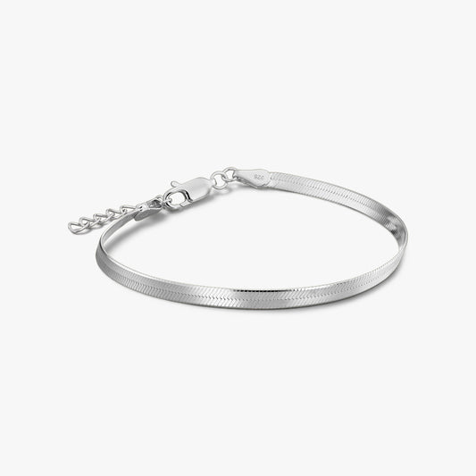 Silver herringbone bracelet with adjustable extender and lobster clasp on a white background.