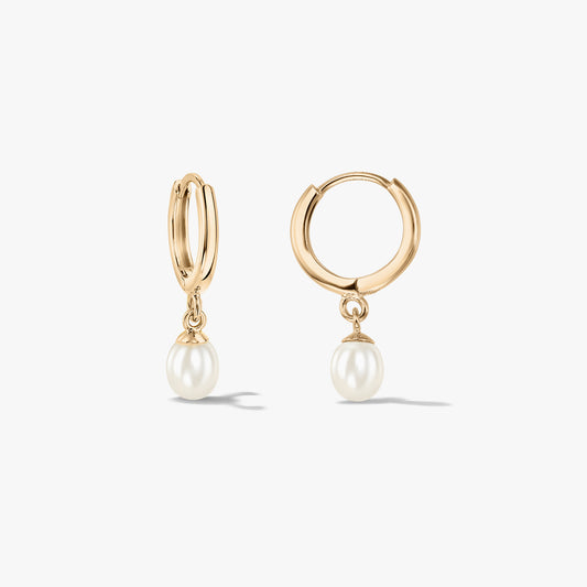 Pair of 14K yellow gold hoop earrings with natural pearl drops on a white background.