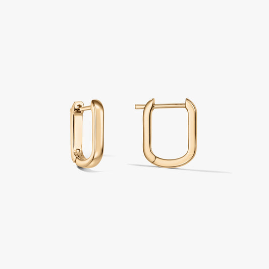 Pair of U-shaped gold-plated sterling silver hoop earrings on a white background, one earring open and one closed.
