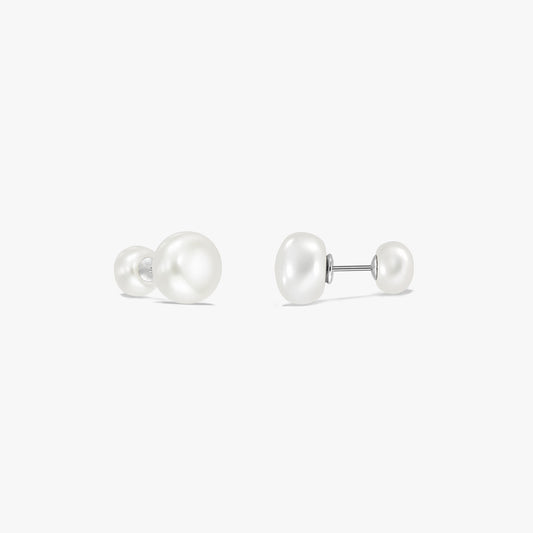 Pair of sterling silver double pearl stud earrings on a white background, each with a large white natural pearl on one end and a smaller pearl on the other connected by a post.