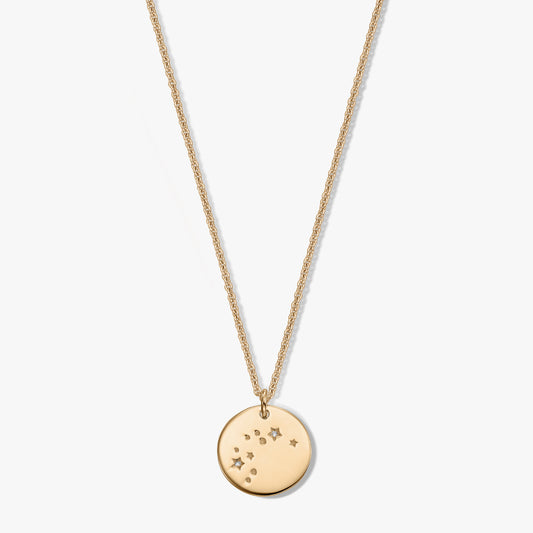 Gold‑toned round pendant necklace with the Aquarius constellation and tiny white sapphire accents on a fine chain, isolated on a white background.