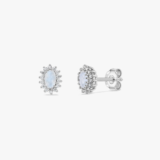 Pair of sterling silver moonstone halo stud earrings on a white background, shown in front and side views with oval cabochon centers and butterfly backs.