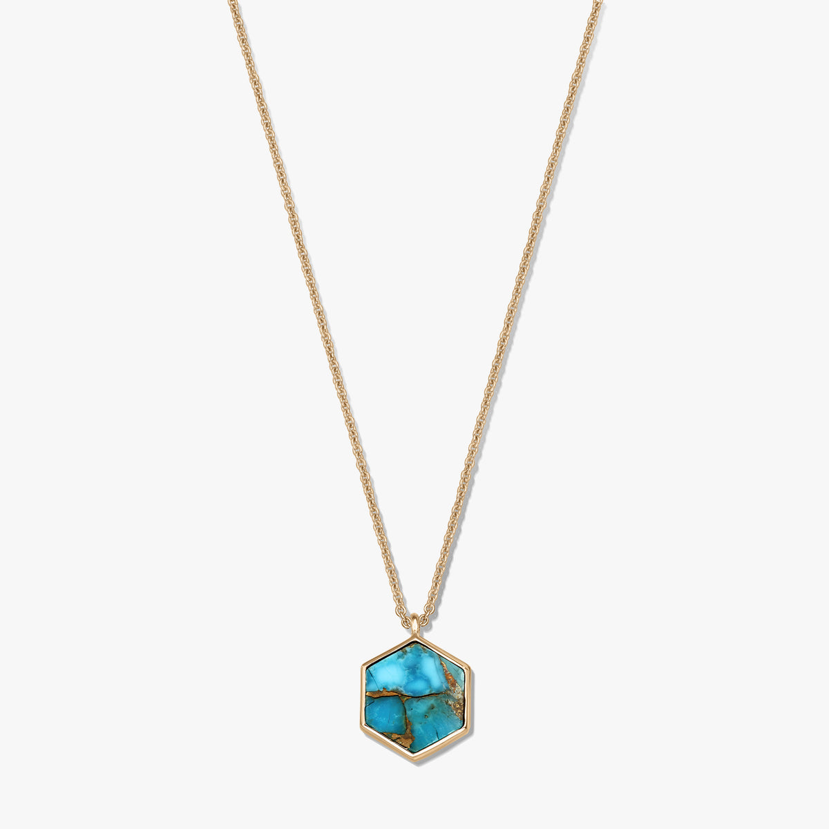 Gold-plated sterling silver necklace with a hexagonal turquoise blue copper pendant on a white background.