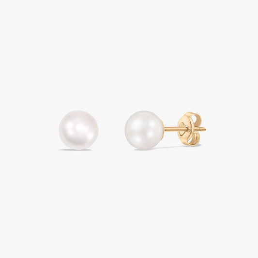 Pair of 14k yellow gold pearl stud earrings with butterfly backs on a white background.