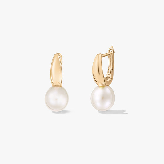 Square studio product photo of gold‑plated silver leverback earrings with round white natural pearls on a white background; one earring is shown open to display the clasp.