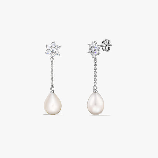 Pair of sterling silver drop earrings with teardrop cultured pearls hanging from a short chain and a small sparkling cluster at the stud, on a white background.