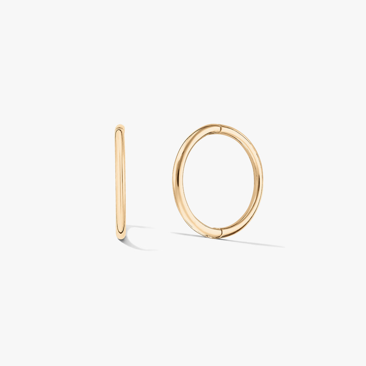 Pair of small yellow-gold hoop earrings on a white background, one shown front-facing and one in side profile.